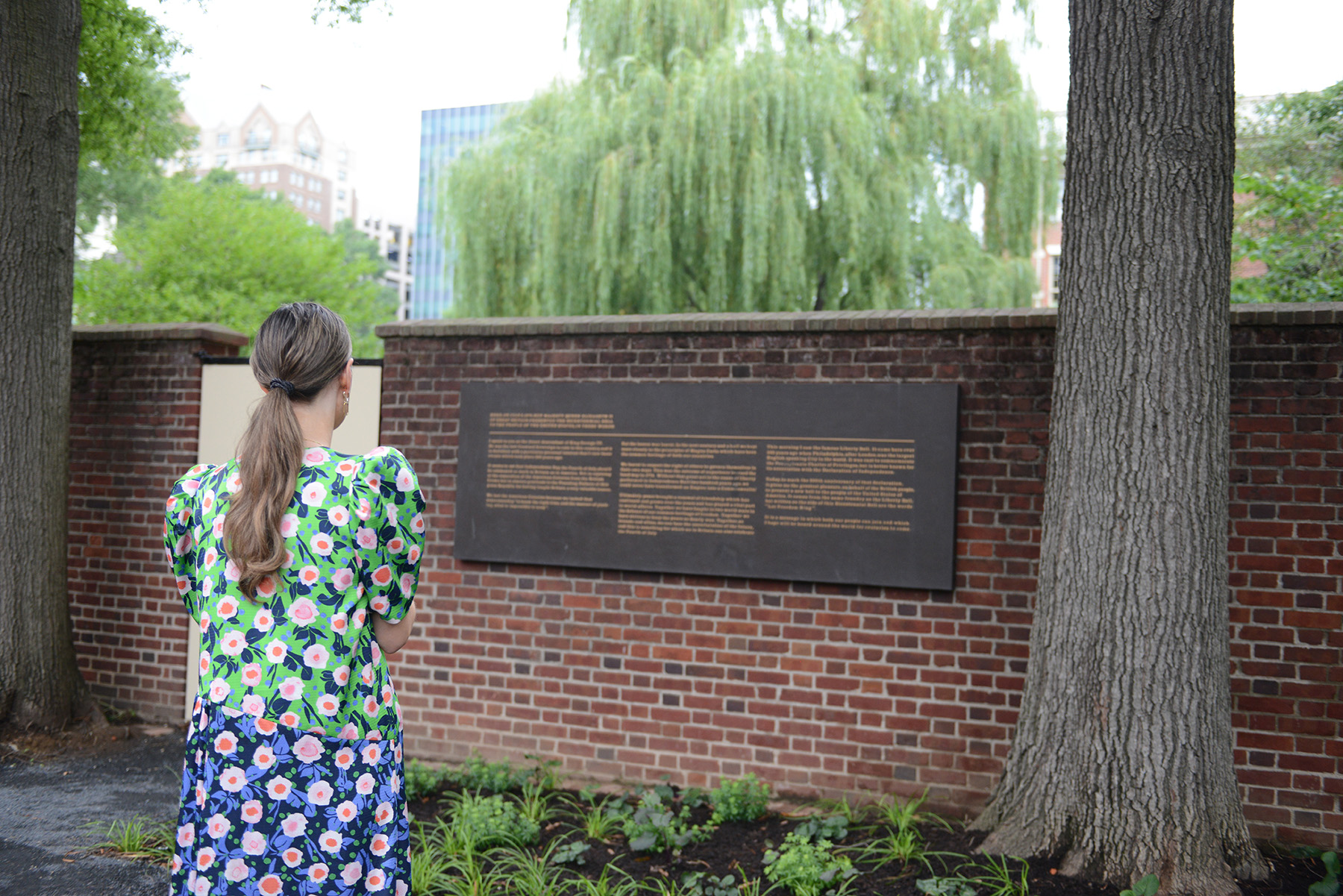 child looking at a plaque